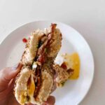 Crispy Bacon Avocado Breakfast Bagel Sandwich.