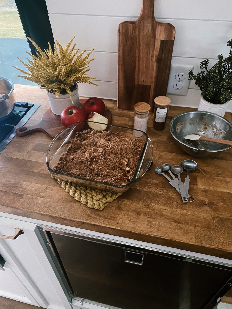 Old Fashioned Apple Crisp with the ingredients displayed on the counter.