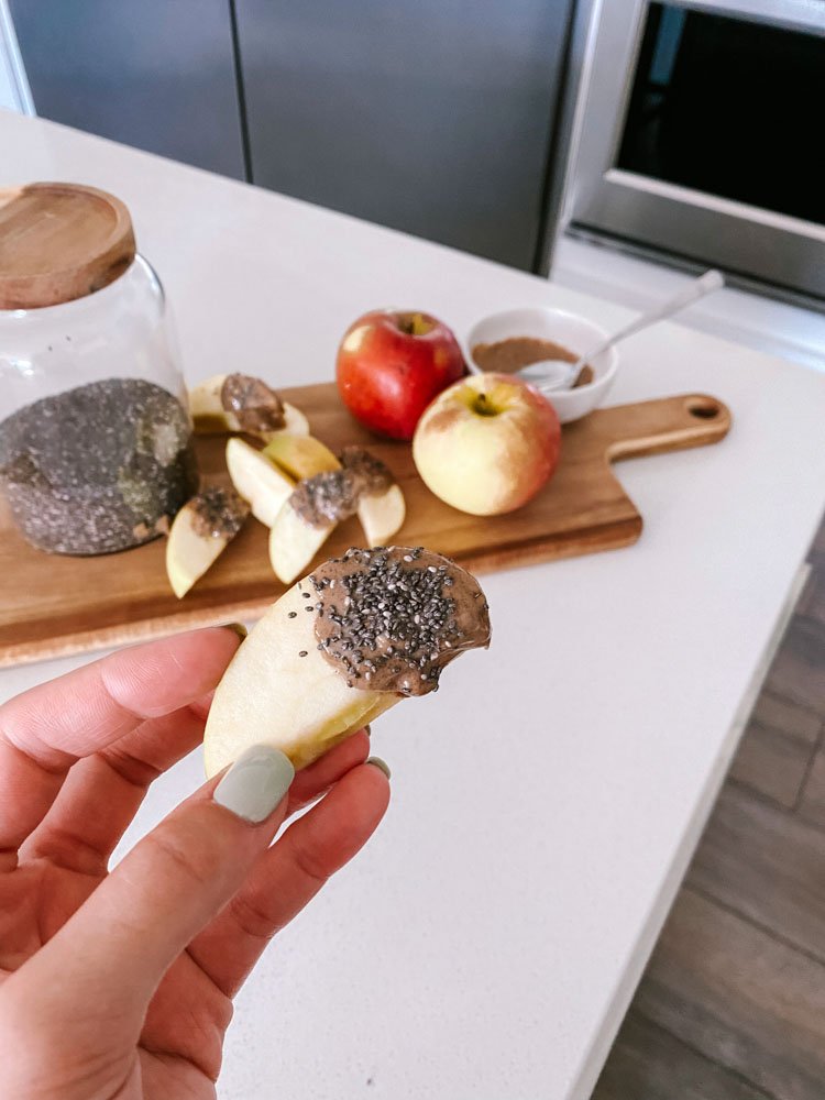 Apple Dipped in Nut Butter and Chia Seeds - a quick and nutritious snack.