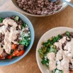 Deconstructed burger bowl with a creamy sauce.