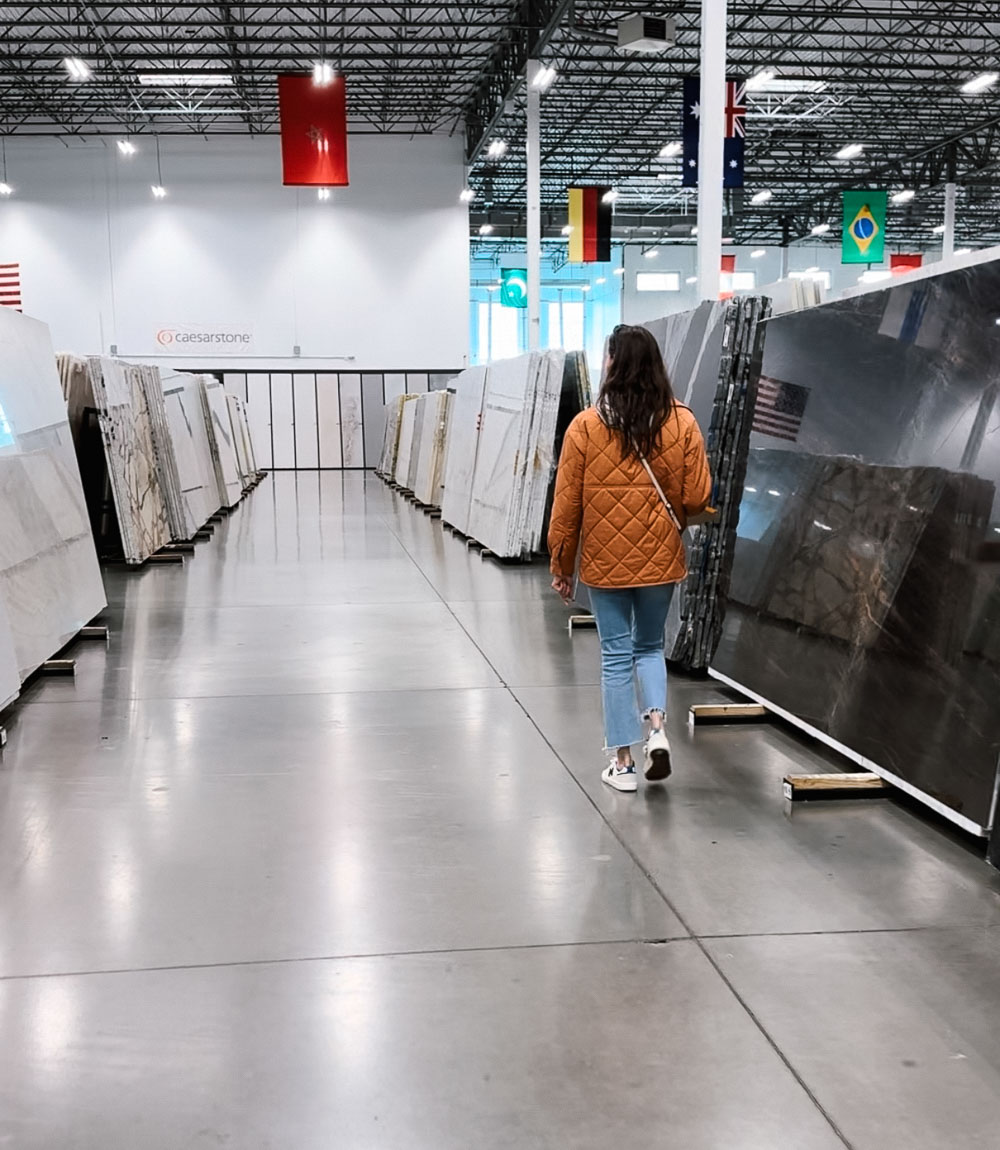 Our Colorado home buildout updates - Abigail Jean walking through a countertop store.